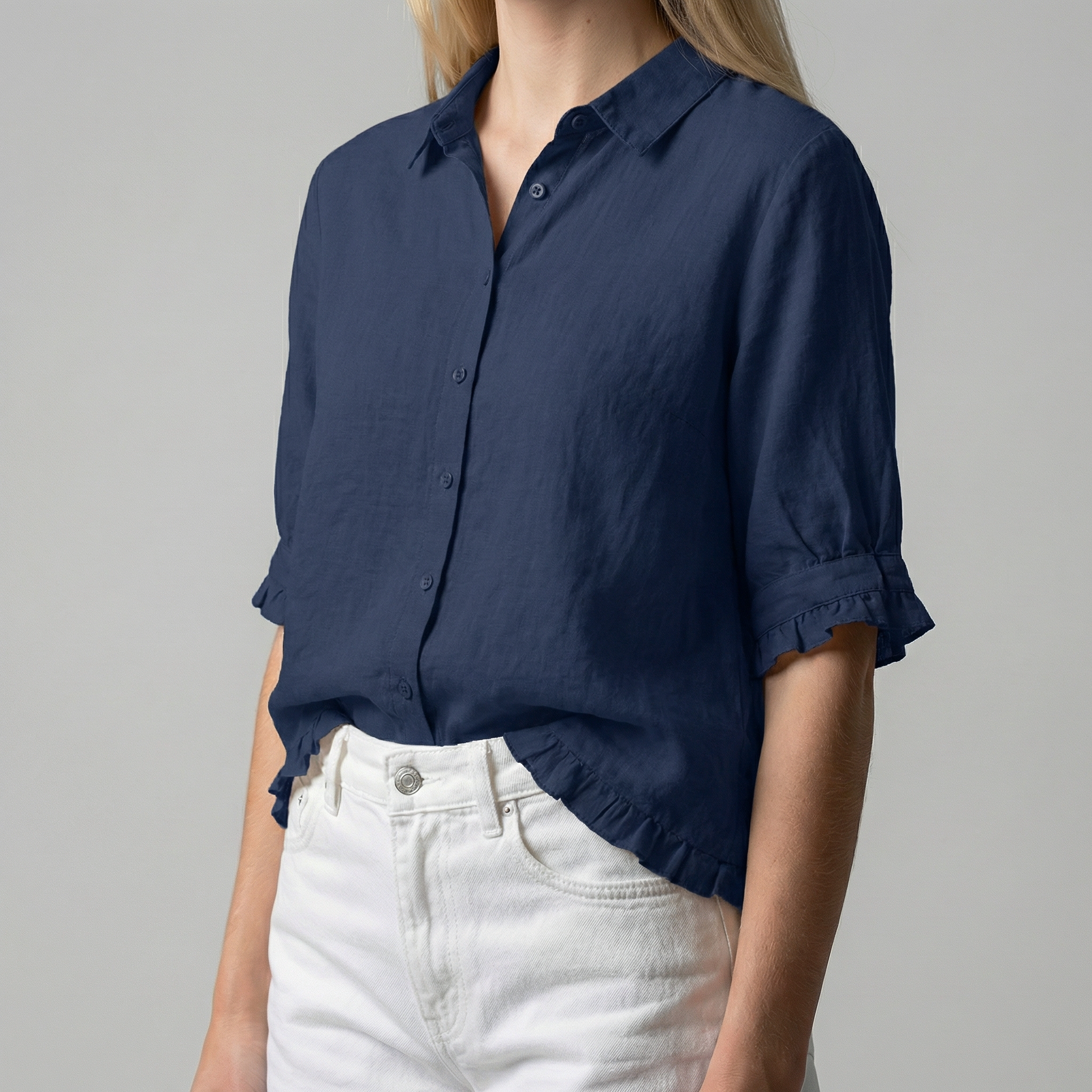 Navy blue button-up shirt worn by a person on a gray background