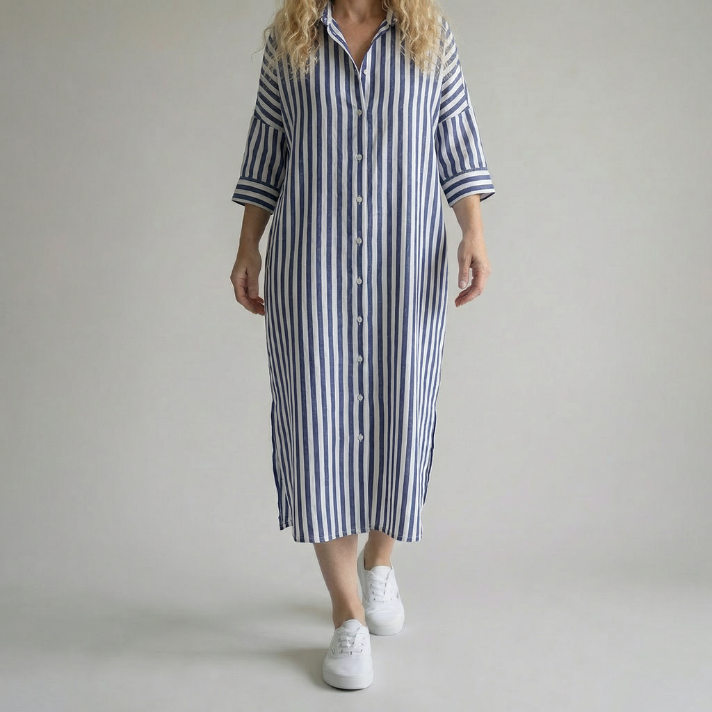 Person wearing a blue and white striped dress on a plain background