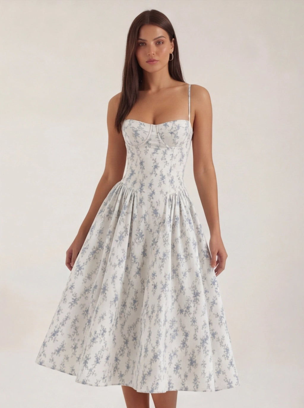 Woman wearing a floral dress against a plain background