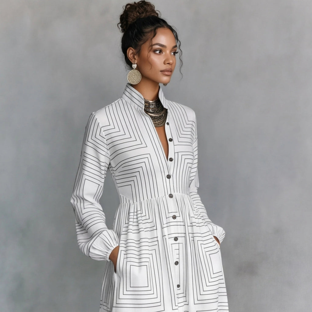 Woman wearing a white geometric patterned dress against a gray background