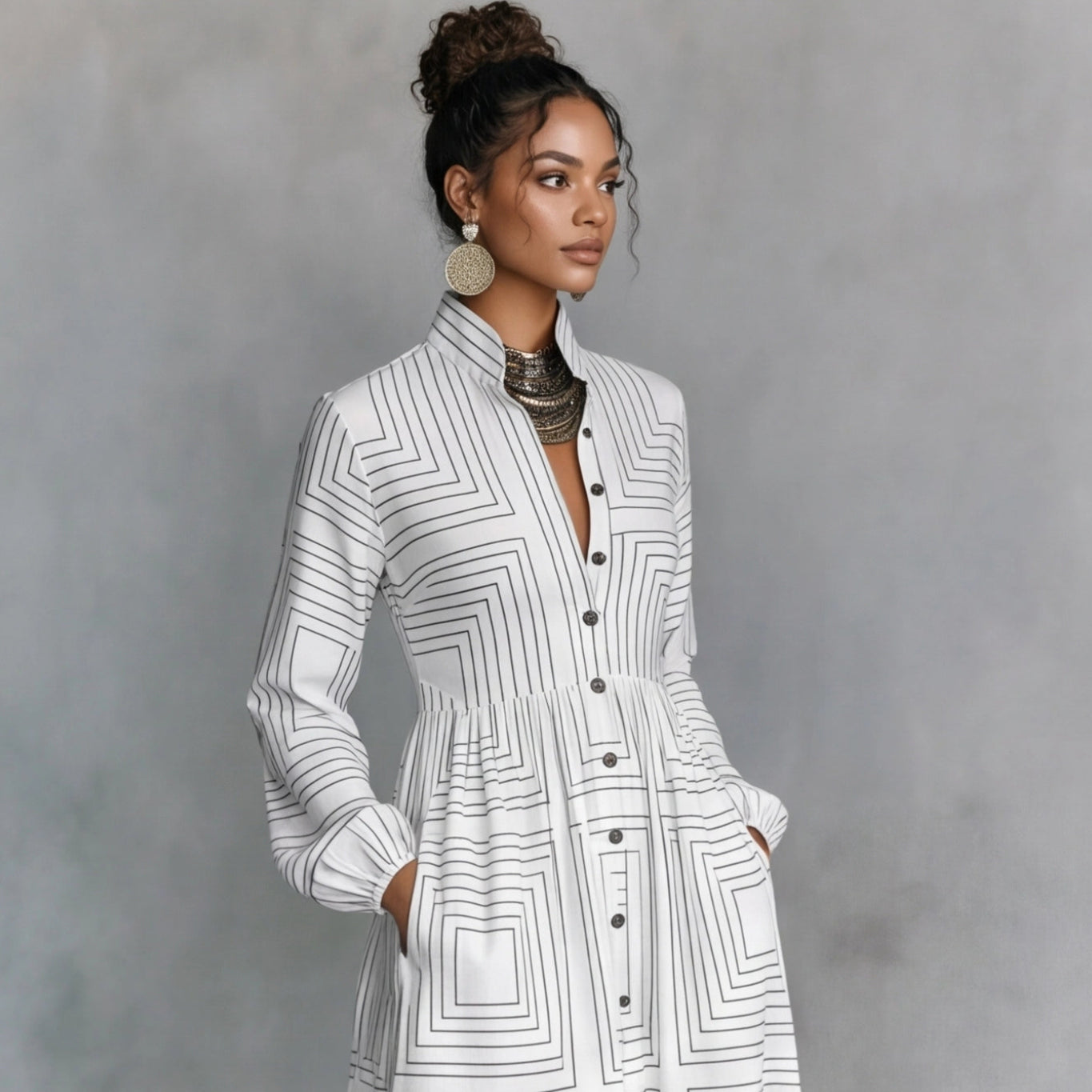 Woman wearing a white geometric patterned dress against a gray background